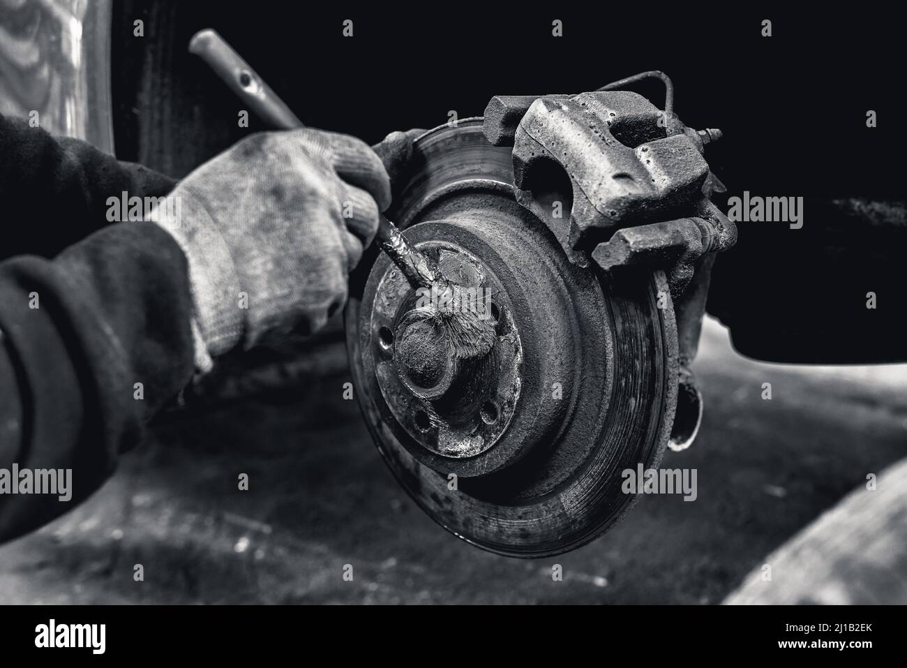 A Mechanic Undoes An Alloy Wheel Nut To Repair It Stock Photo Alamy