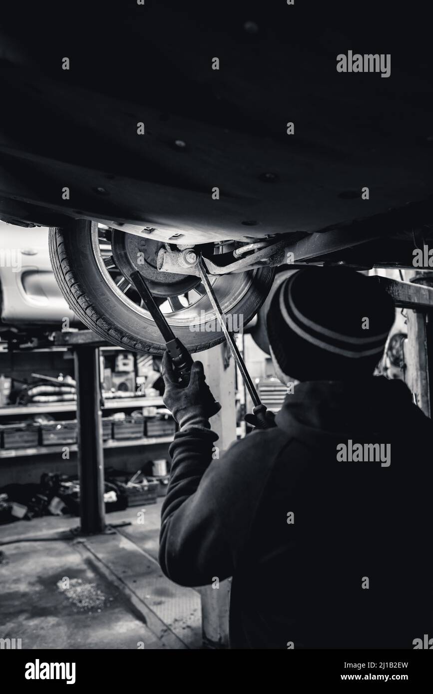 A Mechanic Undoes An Alloy Wheel Nut To Repair It Stock Photo Alamy