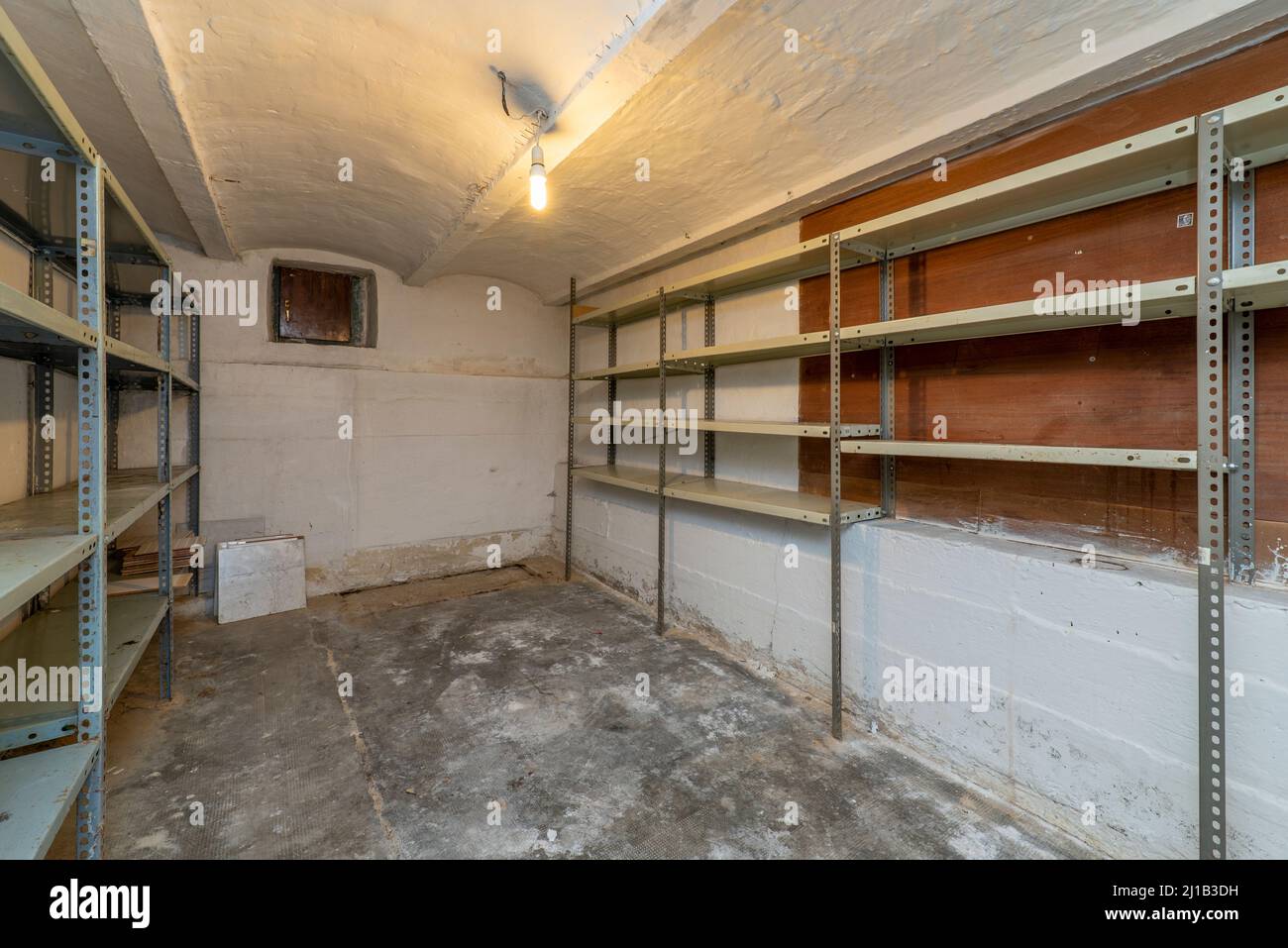 Storage room with walls and floors without reversing and metal shelves ...