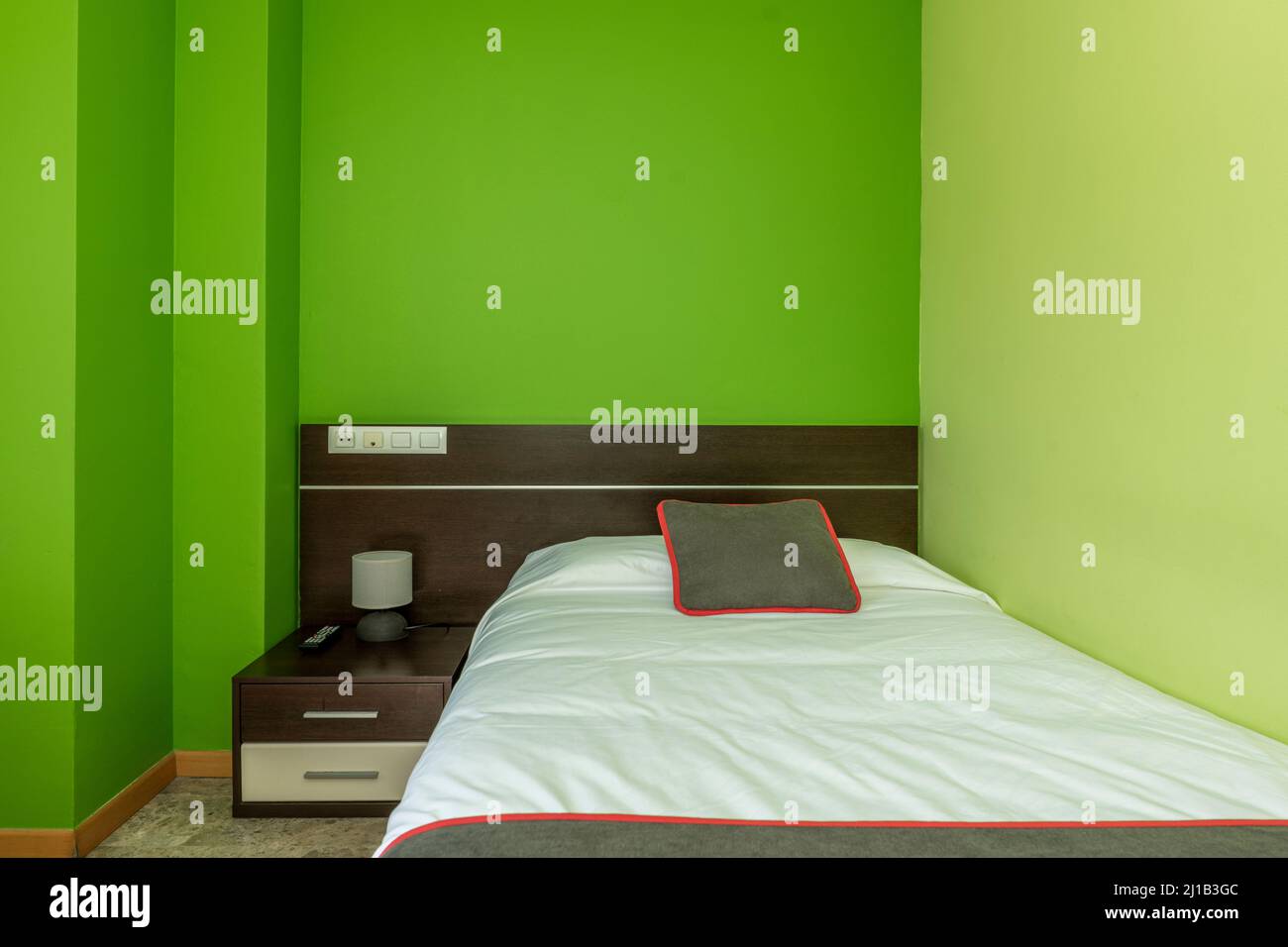 bedroom with small dark wood bed with matching side table and bright