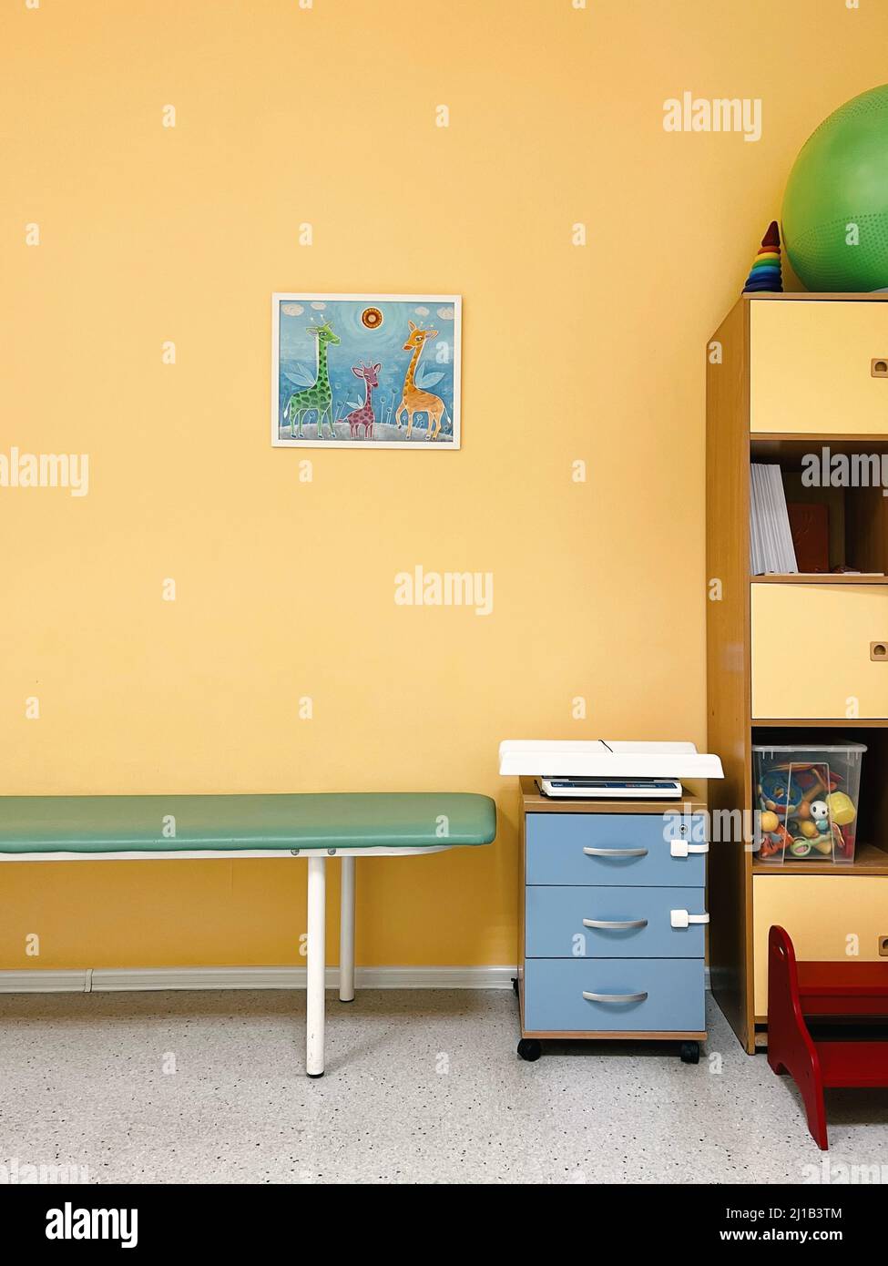 Pediatrician office in bright colors. Children's room. Child protection on bedside table, many toys Stock Photo