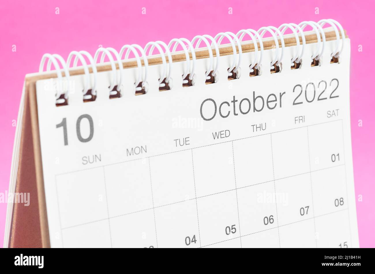 The October 2022 desk calendar on pink background. Stock Photo