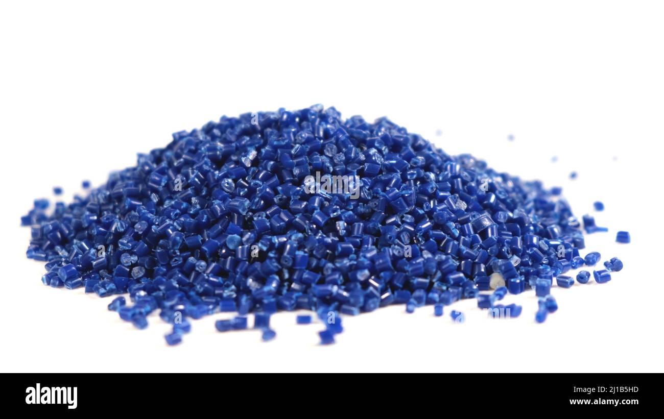 Secondary granule made of polypropylene, Blue Plastic pellets crumbles to the table. Plastic raw materials in granules for industry. Polymer resin Stock Photo