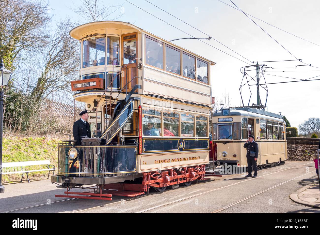 Derbyshire, UK – 5 April 2018: Two trams awaiting passengers at the end of the line tram stop at Crich Tramway Village National Tram Museum Stock Photo