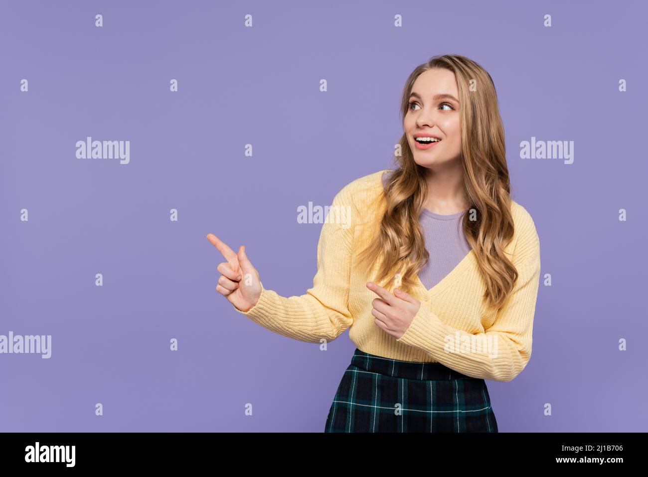 Joyful young woman pointing hi-res stock photography and images - Alamy