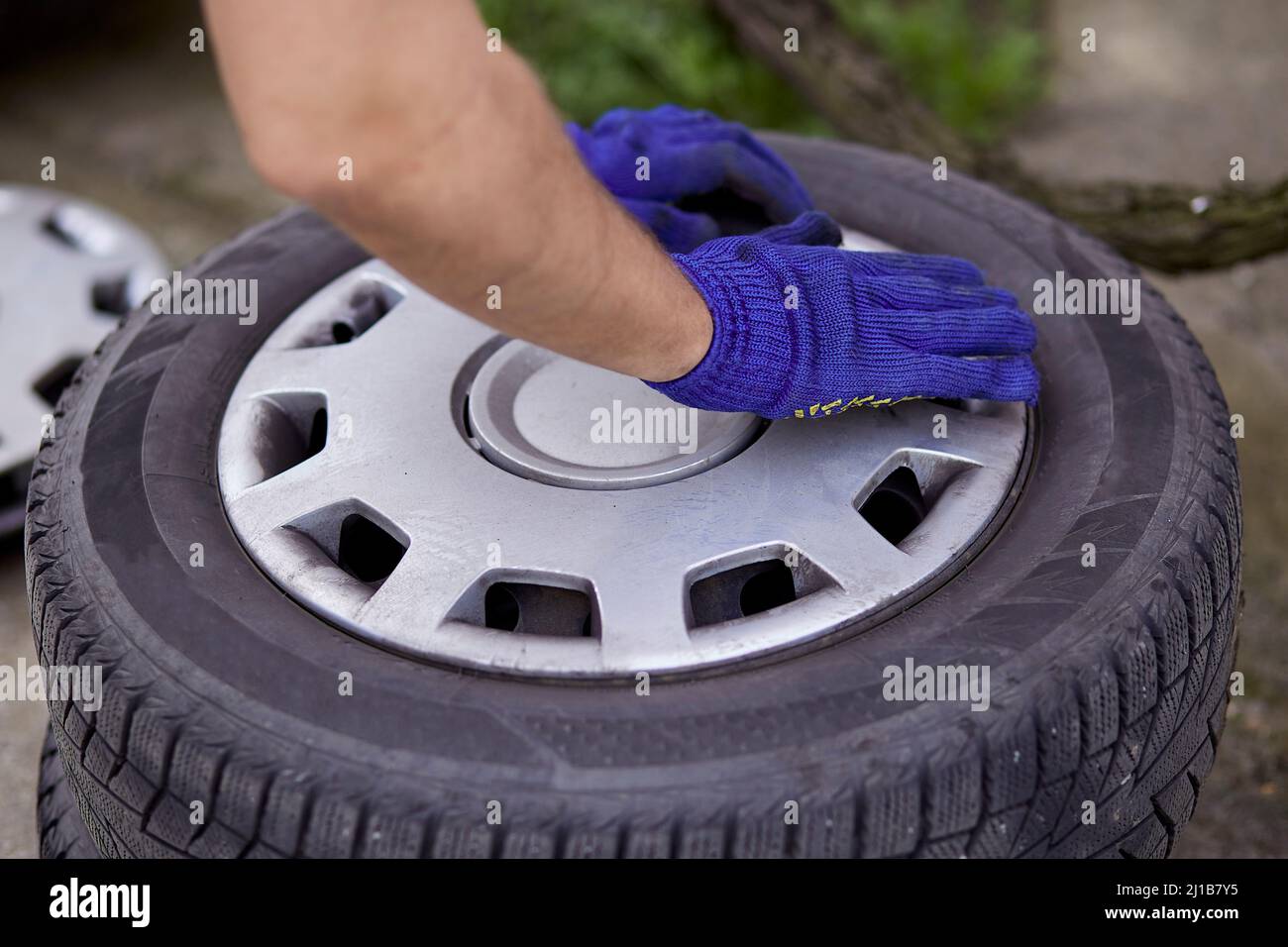 Changing of tires on the car with tools close up. Seasonal work. Safety concept. Stock Photo