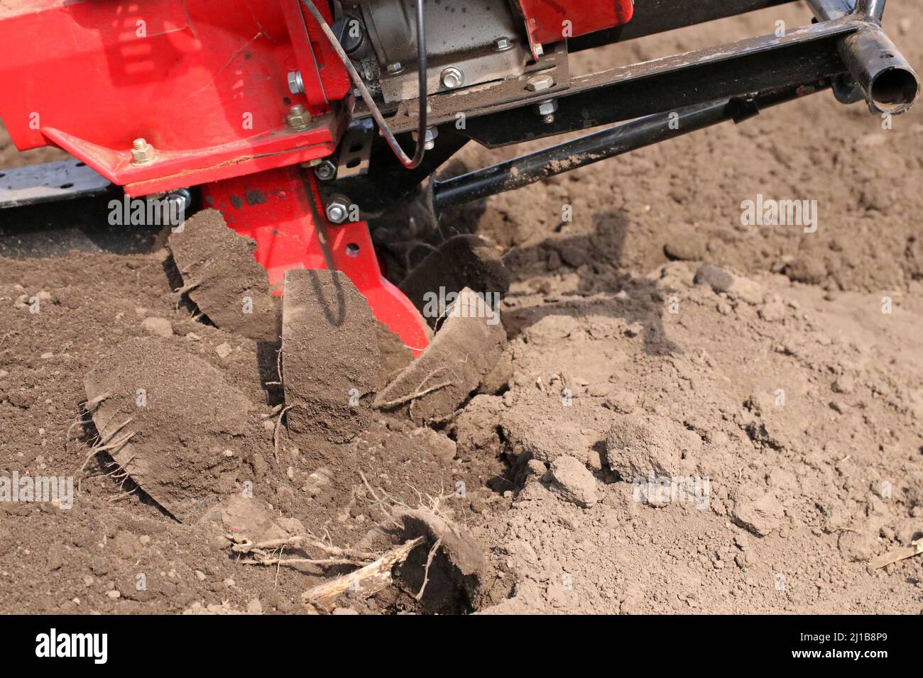 Garden tiller for cultivating field, loosens soil. Handheld motor plow Stock Photo Alamy