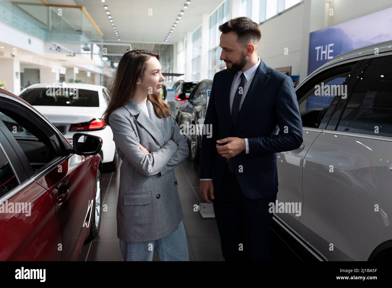 car dealership employees communicate among new cars Stock Photo Alamy