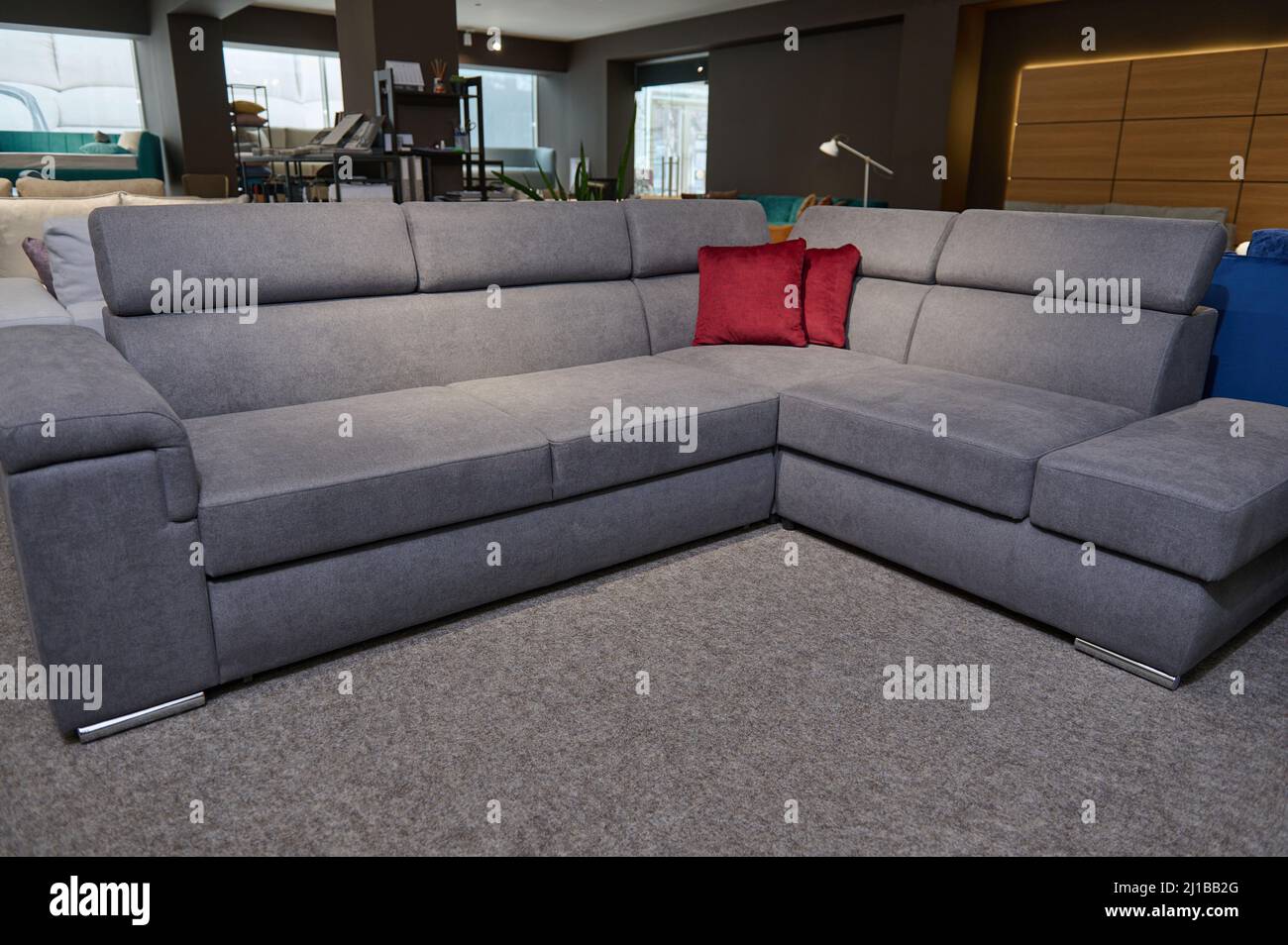 Upholstered furniture displayed for sale in the showroom of furniture  store. Modern stylish sofas, couches and settees with bright colored  cushions fr Stock Photo - Alamy