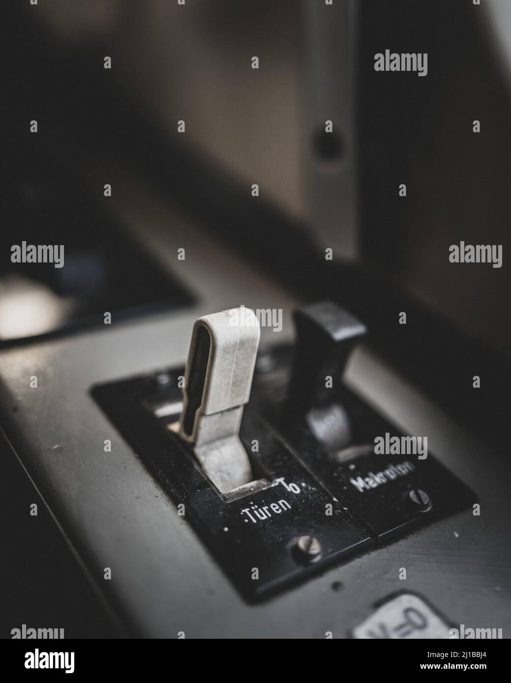 A vertical selective focus shot of the button with german word for