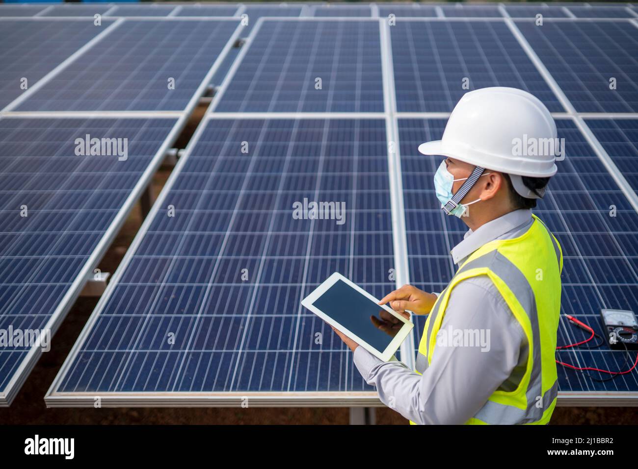 Electrical Engineering Examines Solar Panels in Renewable Energy Generation Stock Photo