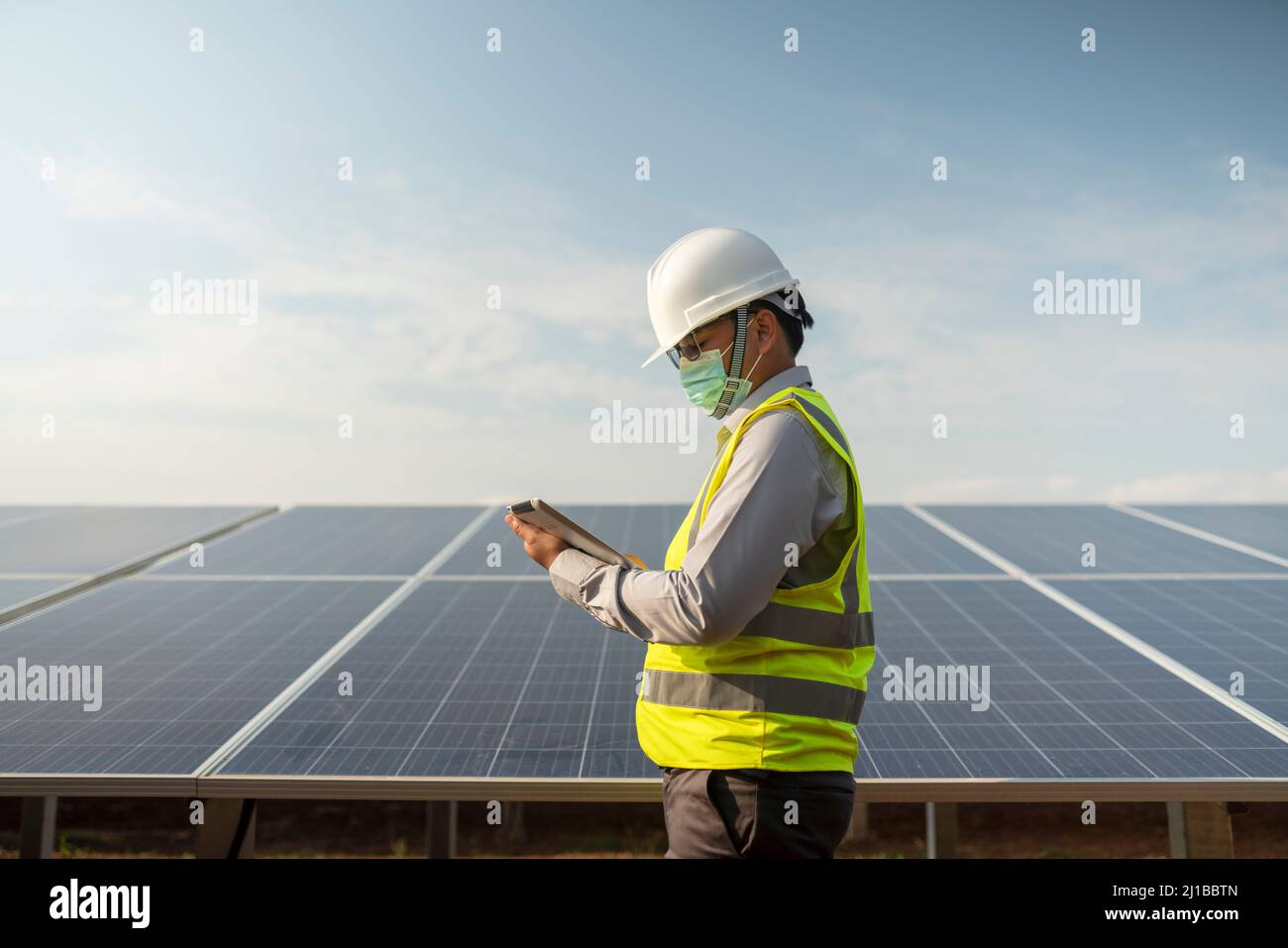 Engineers working to power solar panel renewable power plants in Thailand. Stock Photo