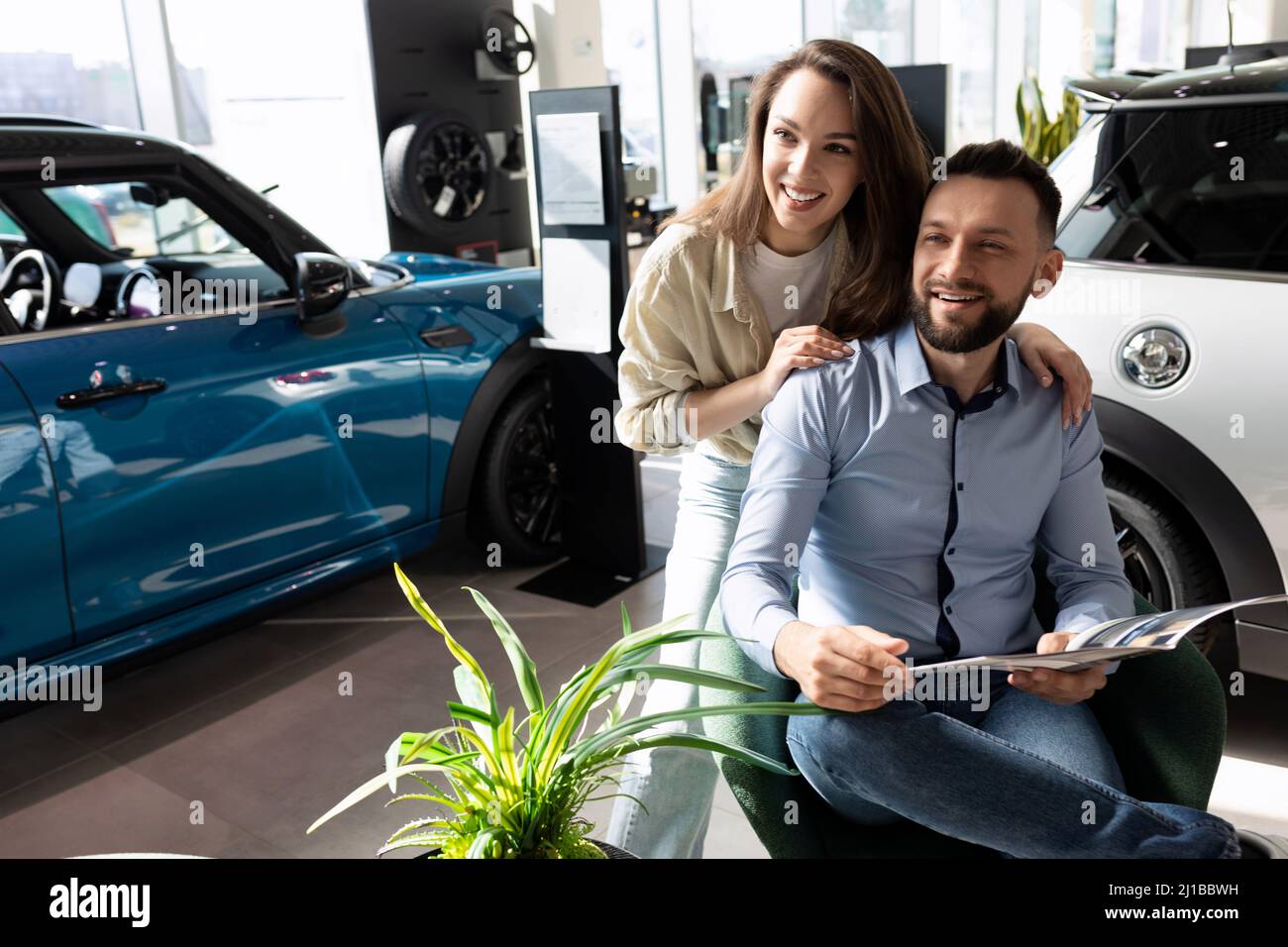 a-married-couple-studying-the-terms-of-new-car-insurance-at-a-car