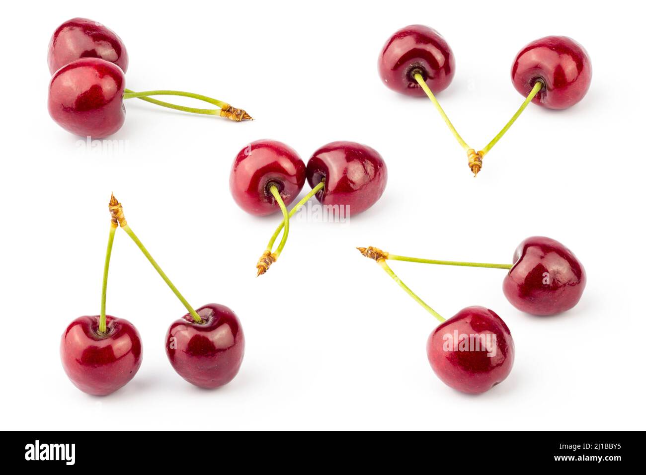 Cherry isolated on white background. Fresh cherries pattern with stems. Cherry set. Stock Photo