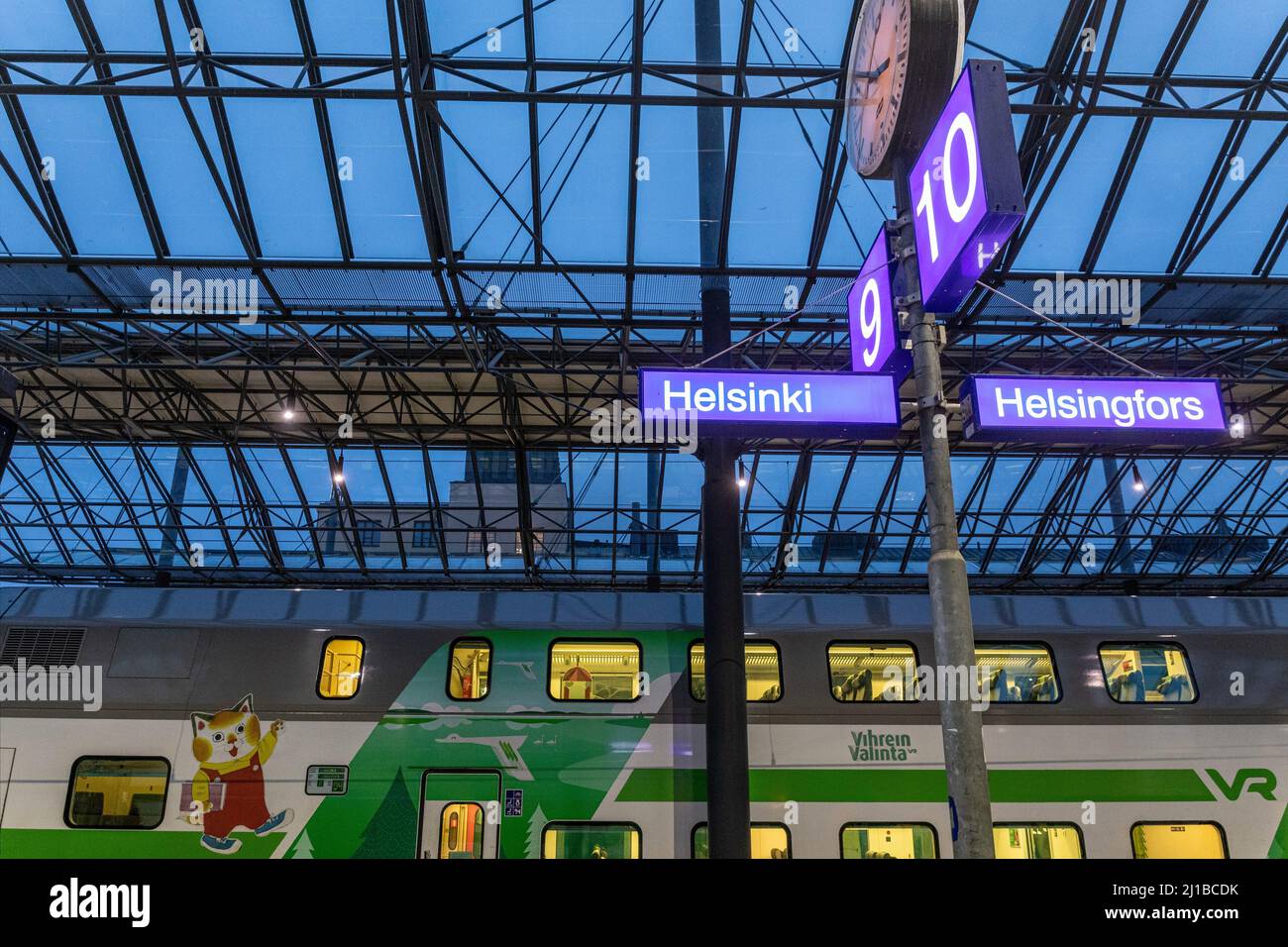 TRAINS AT THE PLATFORM IN THE MAIN TRAIN STATION AT NIGHTFALL, HELSINKI, FINLAND, EUROPE Stock Photo