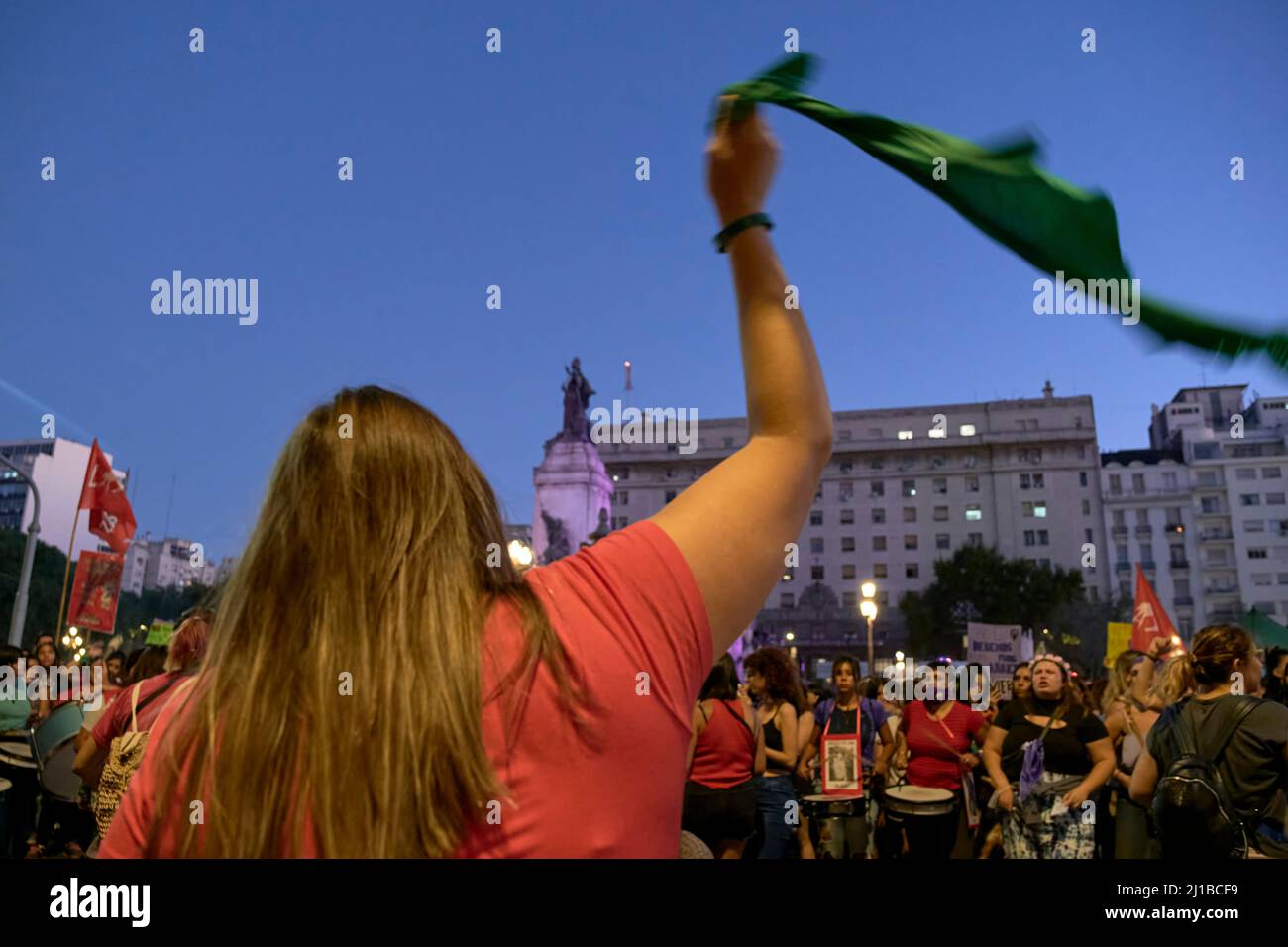 Buenos Aires, Argentina; March 8, 2022: Manuela Castaneira, leader of Nuevo MAS and Las Rojas, seen from behind cheering a group of women and waving a Stock Photo