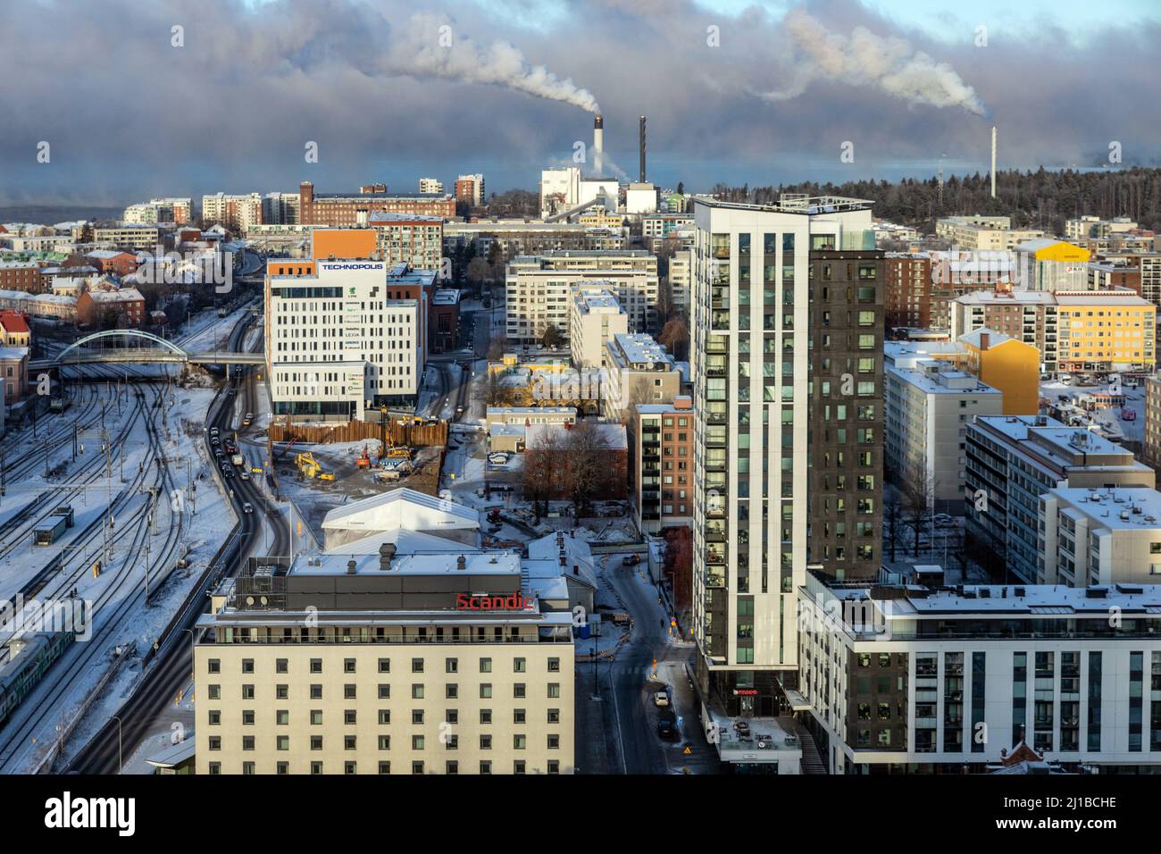 CITY CENTER, TRAIN STATION AND SMOKESTACKS OF THE METSA BOARD TAKO PAPERBOARD FACTORY SEEN FROM THE PANORAMIC MORO SKY BAR, INDUSTRIAL TOWN OF TAMPERE, FINLAND, EUROPE Stock Photo