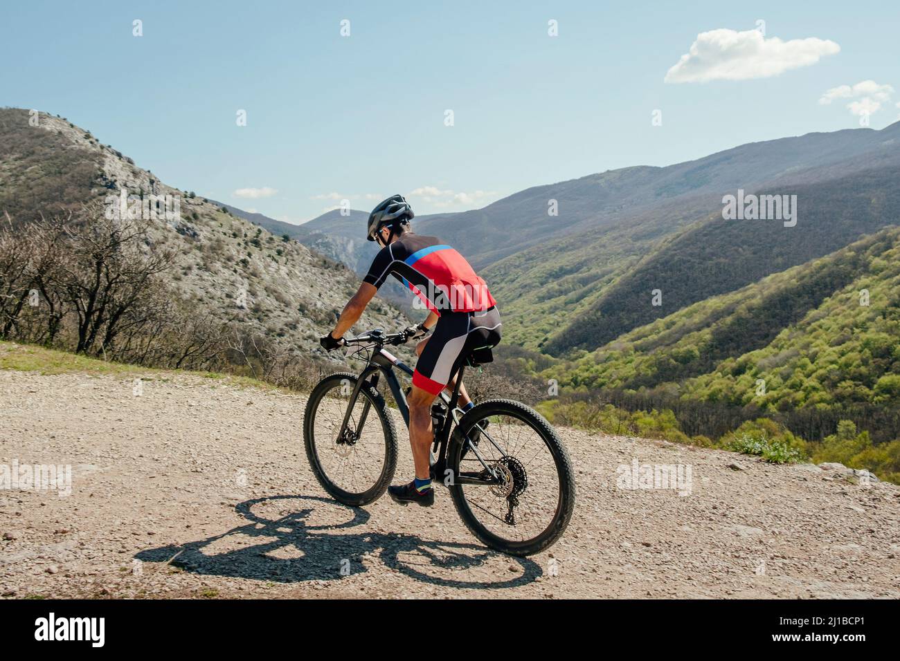 athlete cyclist riding mountain bike on mountain trail Stock Photo