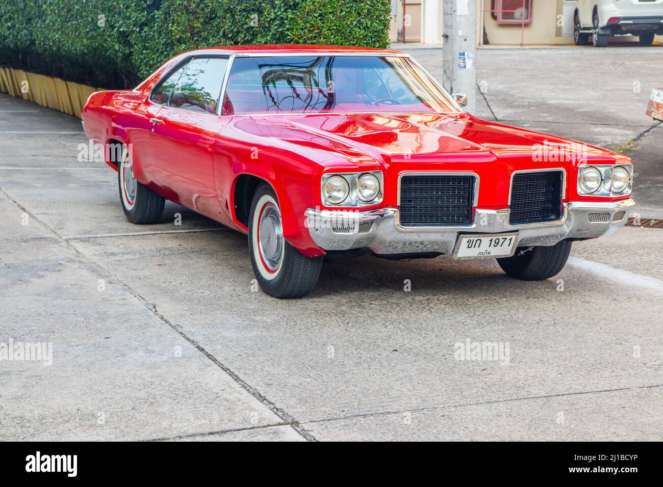 An American red-painted classic car, Oldsmobile Delta 88 from 1971, in Bangkok, Thailand Stock Photo