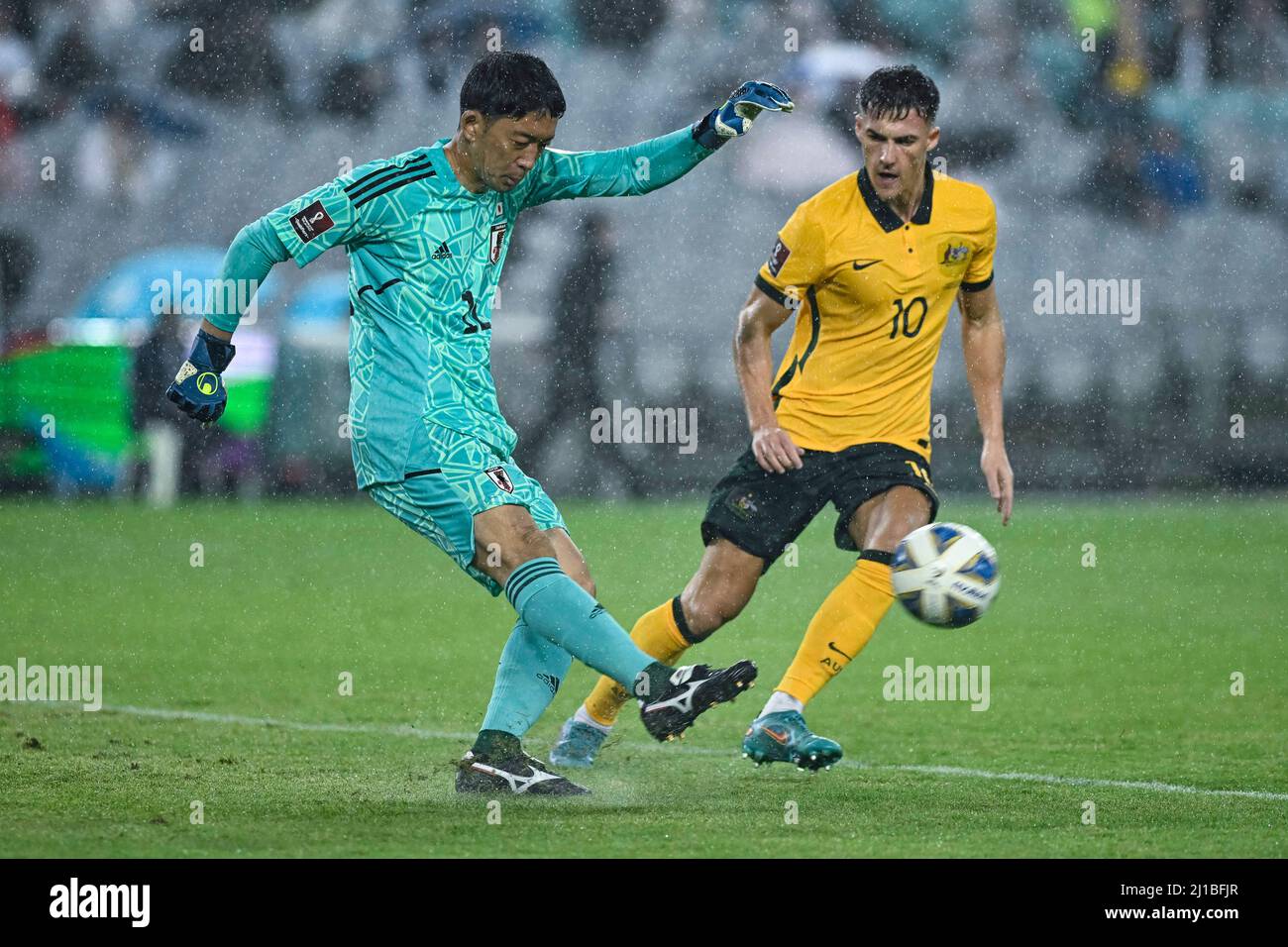 Sydney, New South Wales, Australia. 24th March 2022; Stadium Australia, Sydney, New South Wales, Australia; World Cup Football Qualification, Australia versus Japan; Shuichi Gonda of Japan clears the ball under pressure from Ajdin Hrustic of Australia Credit: Action Plus Sports Images/Alamy Live News Stock Photo