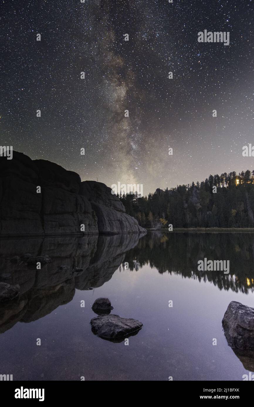 A vertical shot of Sylvan Lake in South Dakota, USA at the starry night ...