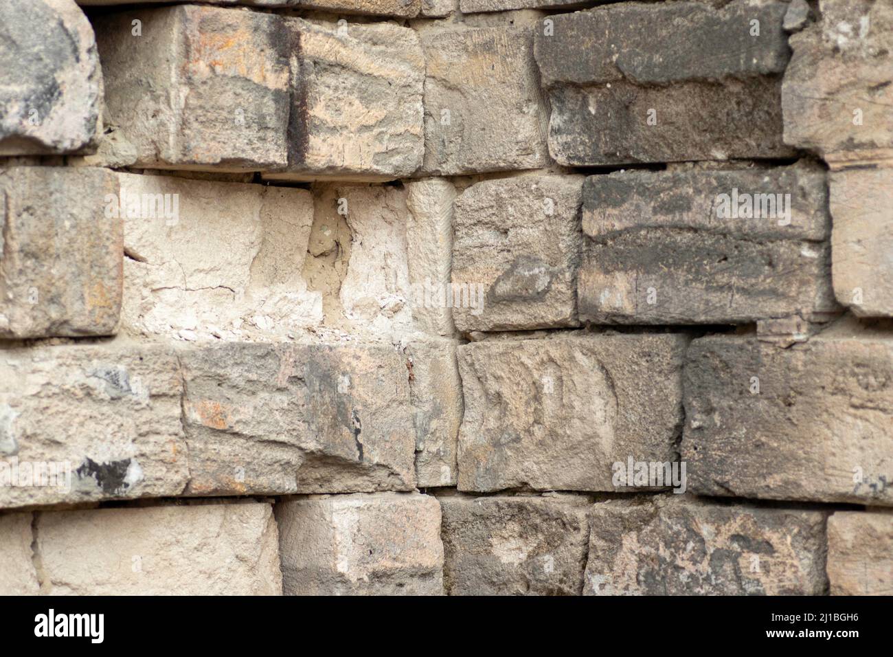 old wall made of white roll, partly destroyed wall surface Stock Photo