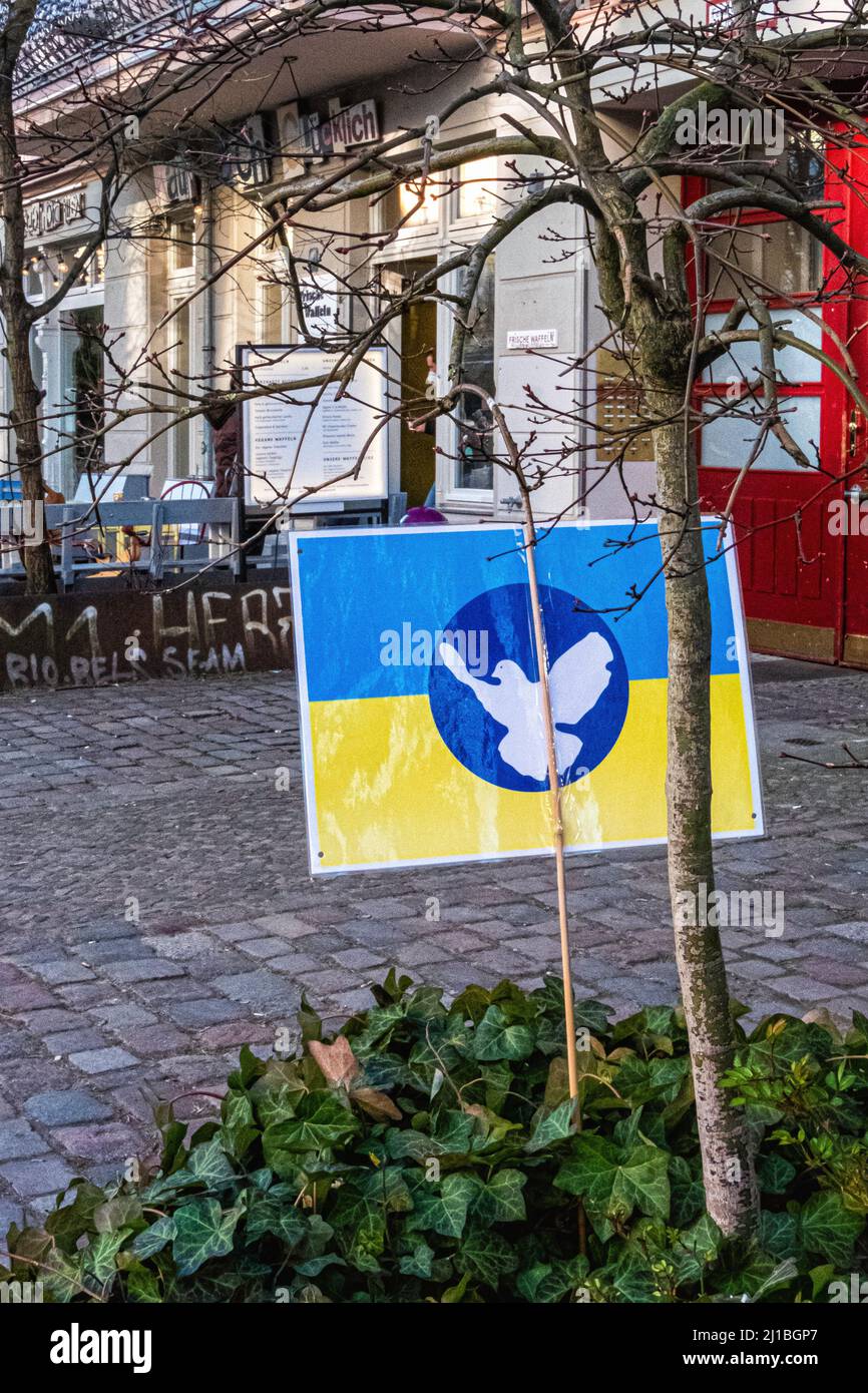 Ukrainian flag on poster on pavement during Russian Invasian of Ukraine, Oderberger strasse, Prenzlauer Berg, Berlin Stock Photo