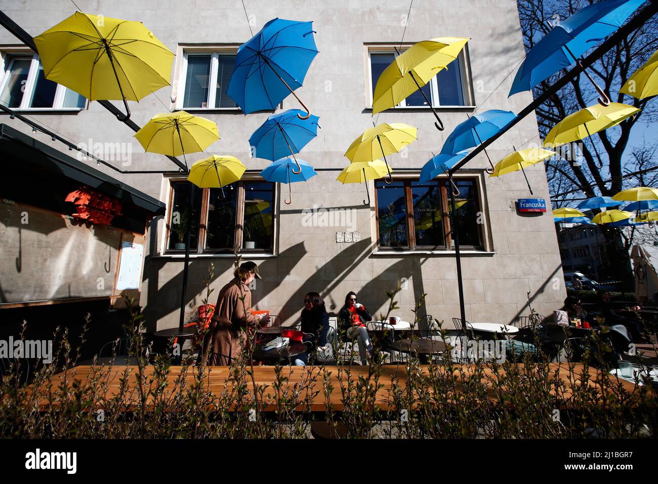 Blue and yellow coloured umgrellas are seen decorating an outdoor patio in  support of Ukraine at the Francuska 30 coffee place in the Saska Kempa neig  Stock Photo - Alamy