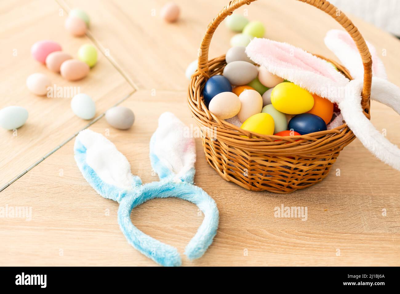 Easter concept. Eggs, Bunny's ears on festive Easter table background top-down copy space Stock Photo