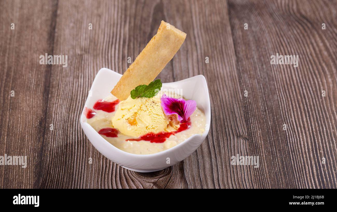 dessert of rice, milk and peach ice cream, closeup Stock Photo Alamy