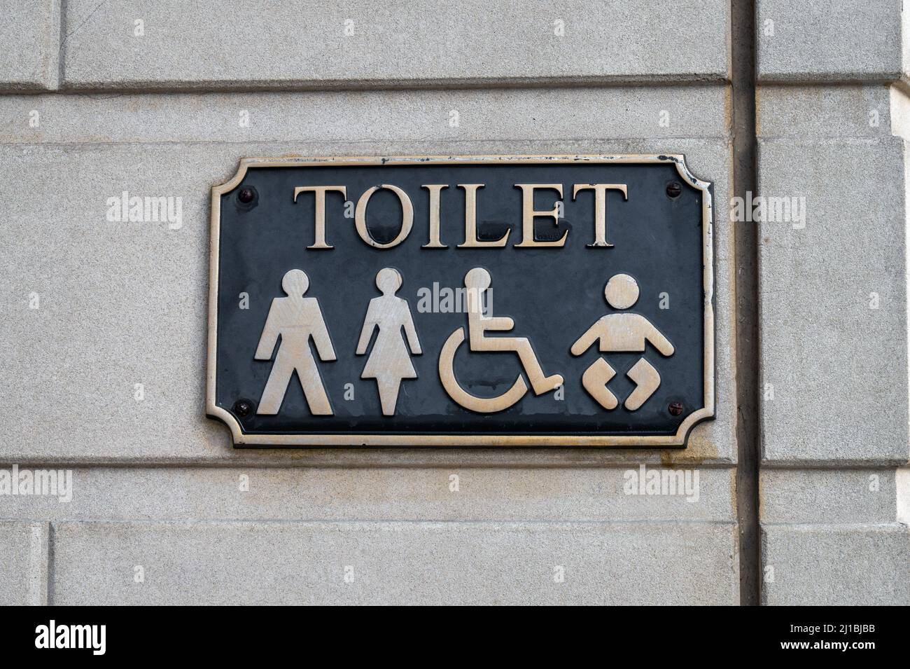 Sign for public toilets with a simble of a man, women, baby and disabled person Stock Photo