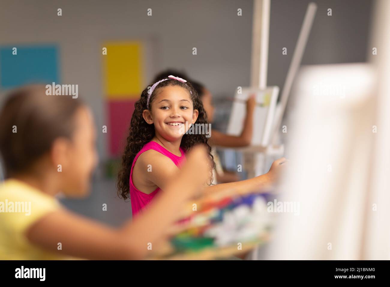 Happy schoolgirl looking classmate drawing hi-res stock photography and ...