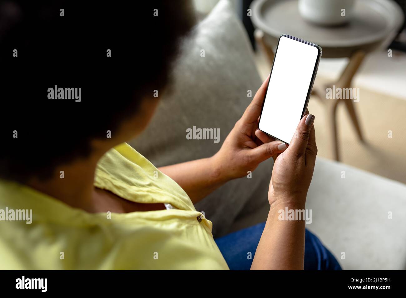 Closeup african american mid adult woman using smart phone with blank