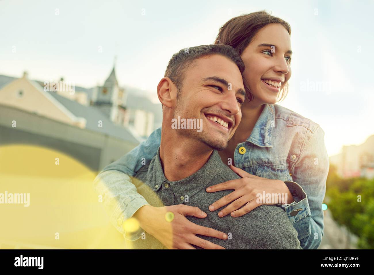 Love makes time for fun. Shot of a happy young couple enjoying a piggyback ride in the city. Stock Photo