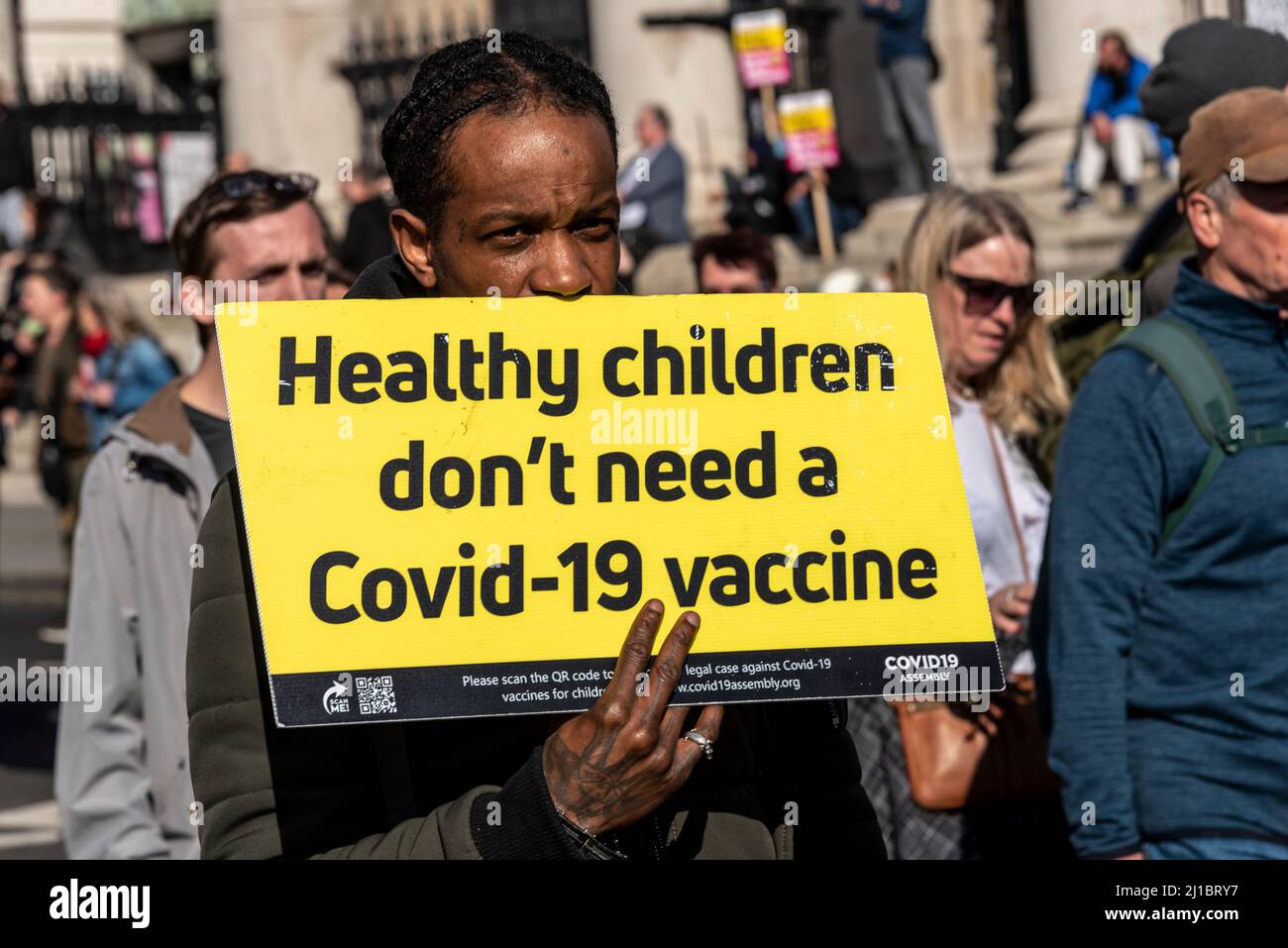 Protest taking place against vaccinating children for Covid 19, joined by anti-vaxxers. Placard stating healthy children don't need a Covid 19 vaccine Stock Photo