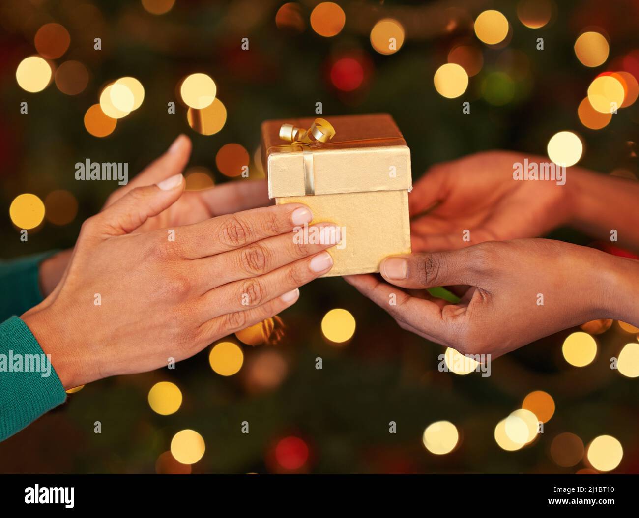 Tis better to give than to receive. Shot of two unrecognizable women exchanging gifts at Christmas. Stock Photo