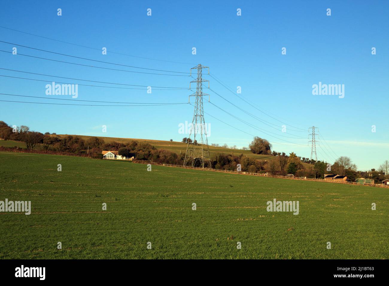 View from field of electricity pilons and North Downs close to Stowting near Ashford, Kent, England, United Kingdom Stock Photo