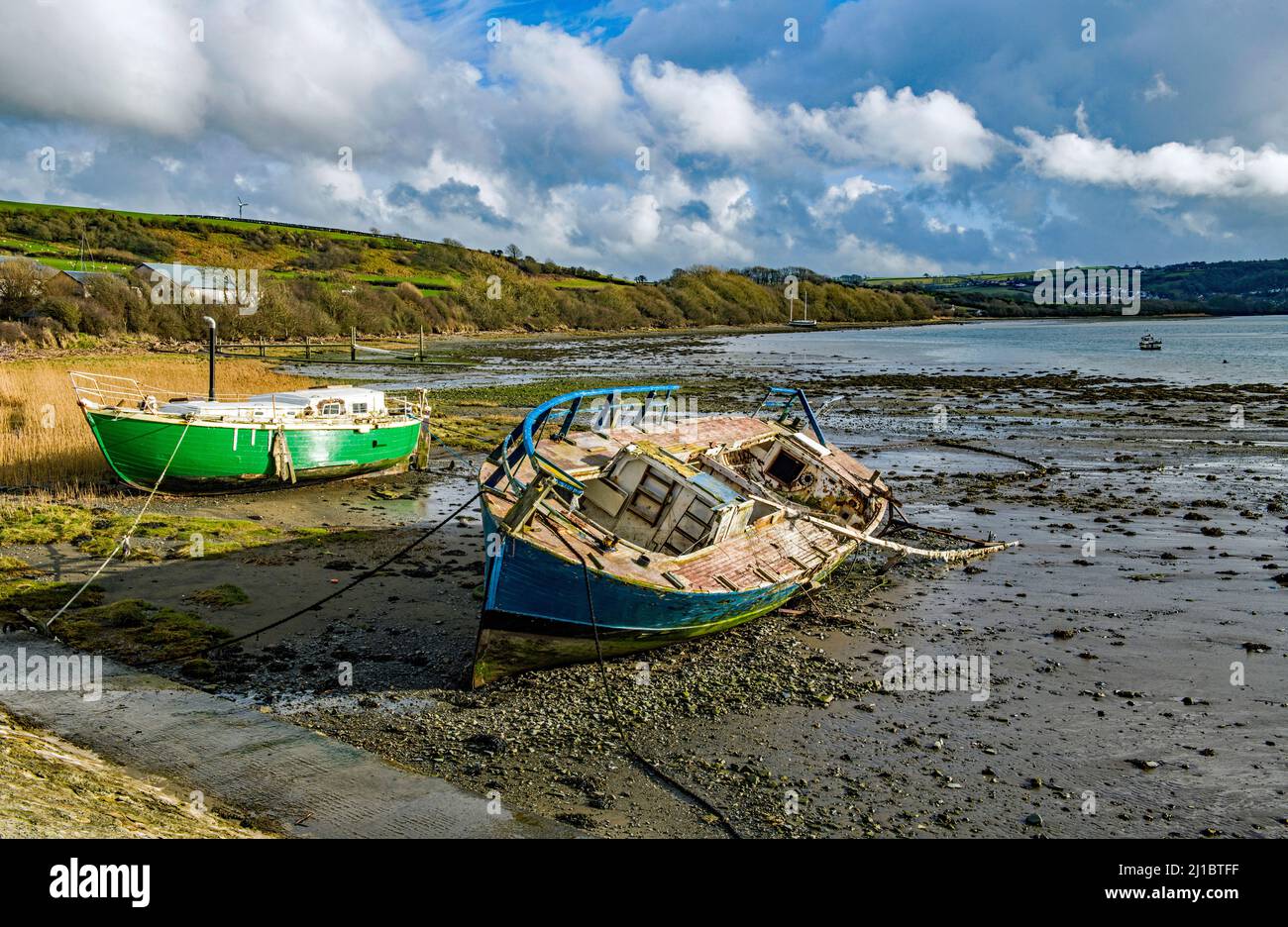 Two moored boats on the estuary of the River Teifi near Gwbert on the Ceredigion/Cardiganshire coast West Wales Stock Photo