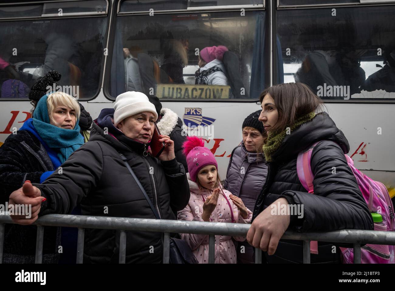 Refugees from Ukraine have reached the central refugee collection point in a logistics center near Korczowa in the Polish-Ukrainian border area. Here they are supplied with food and clothing and then transported onward by bus to other cities. Stock Photo