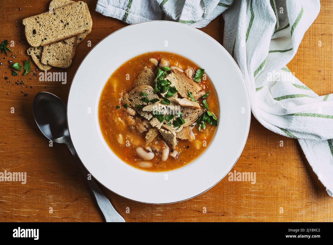 Vegan meal, plant based food, top view. Bowl of lentils soup with beans