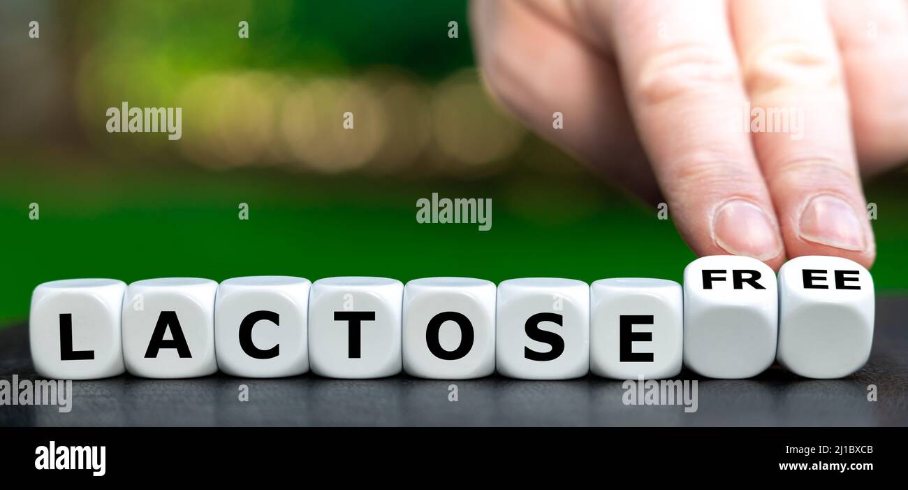 Hand turns dice and changes the expression "lactose" to "lactose free