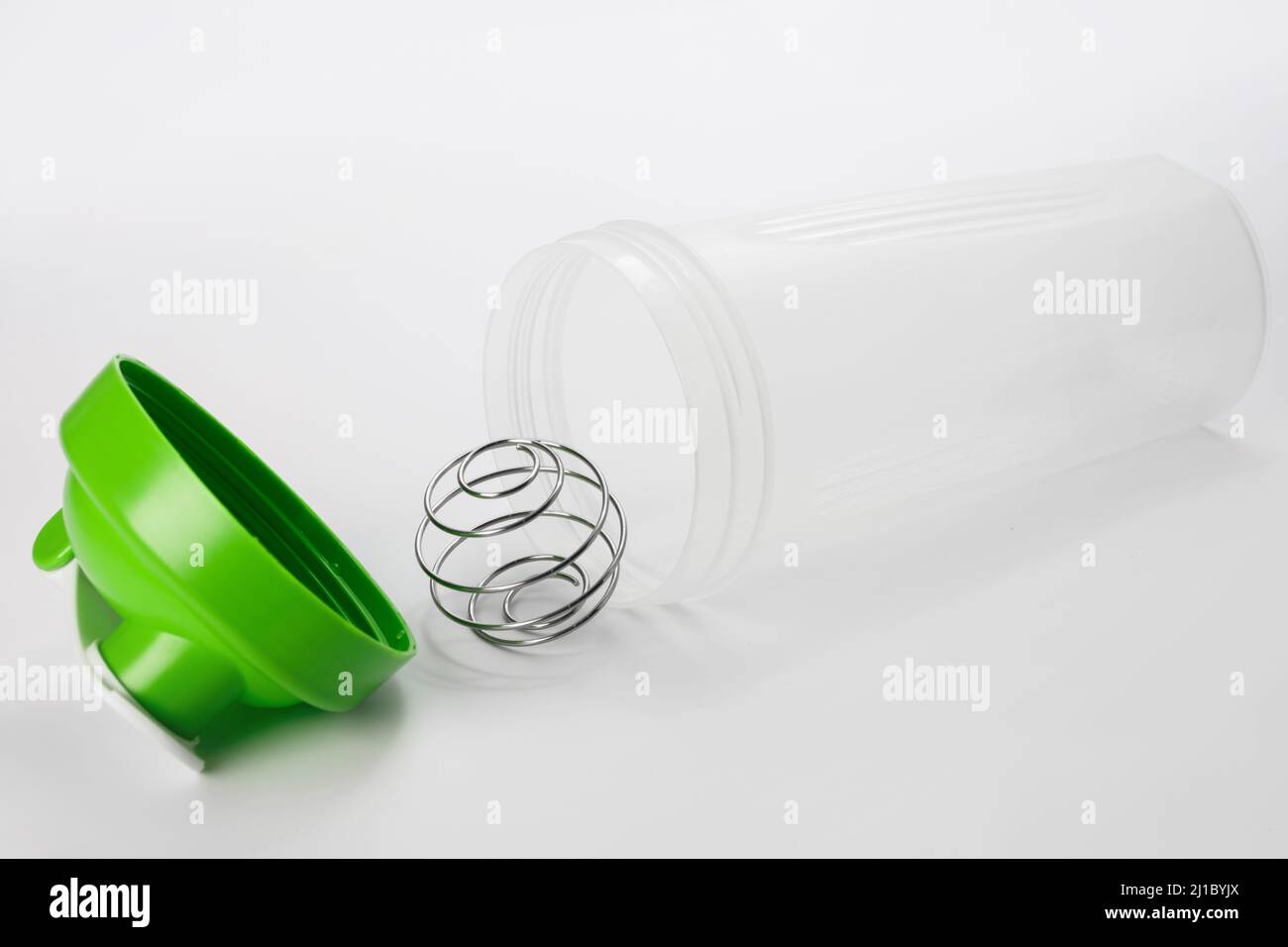 Green protein shaker with mixing ball on white Stock Photo Alamy