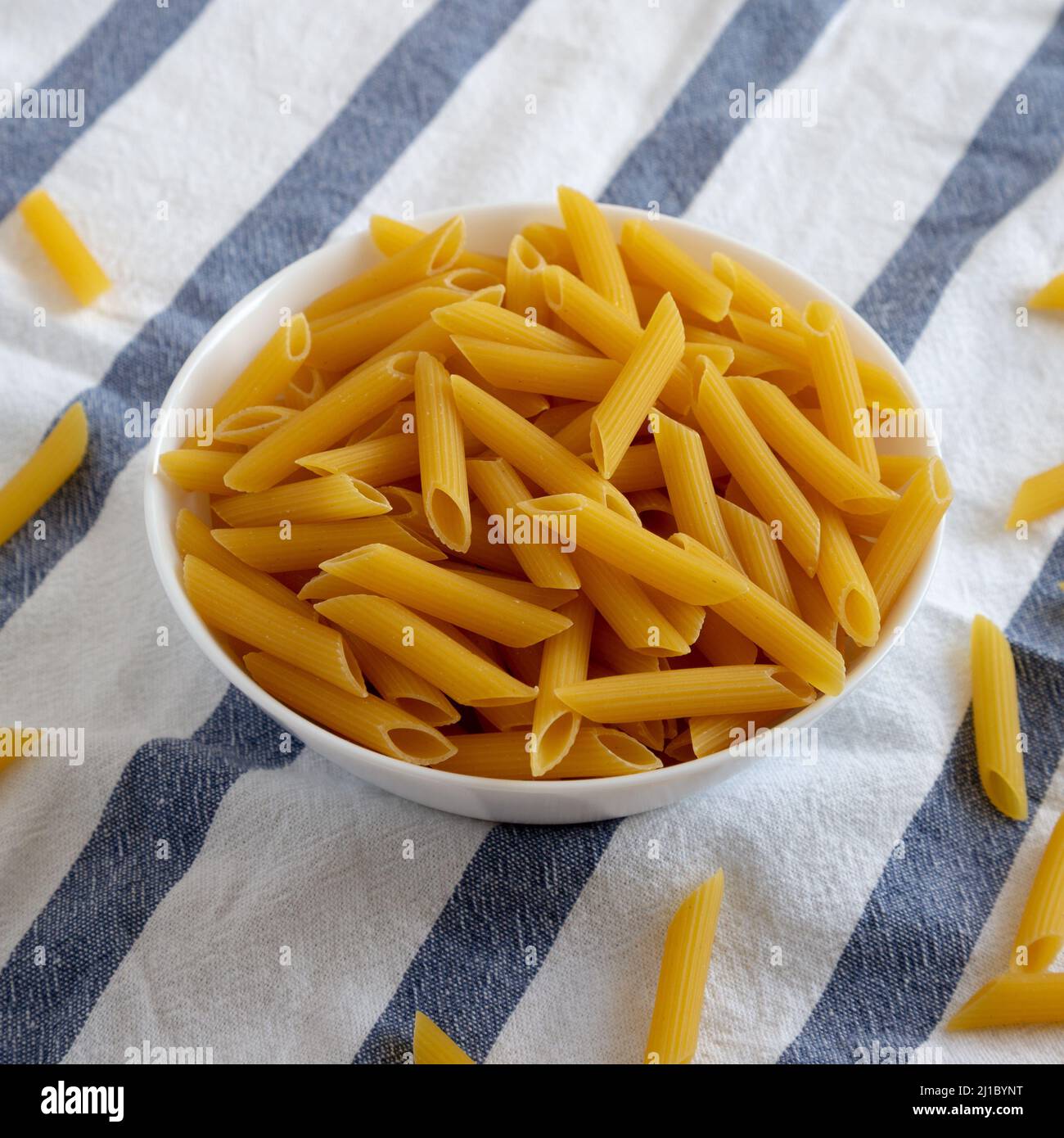 Homemade Raw Dry Penne Pasta in a White Bowl, side view Stock Photo Alamy