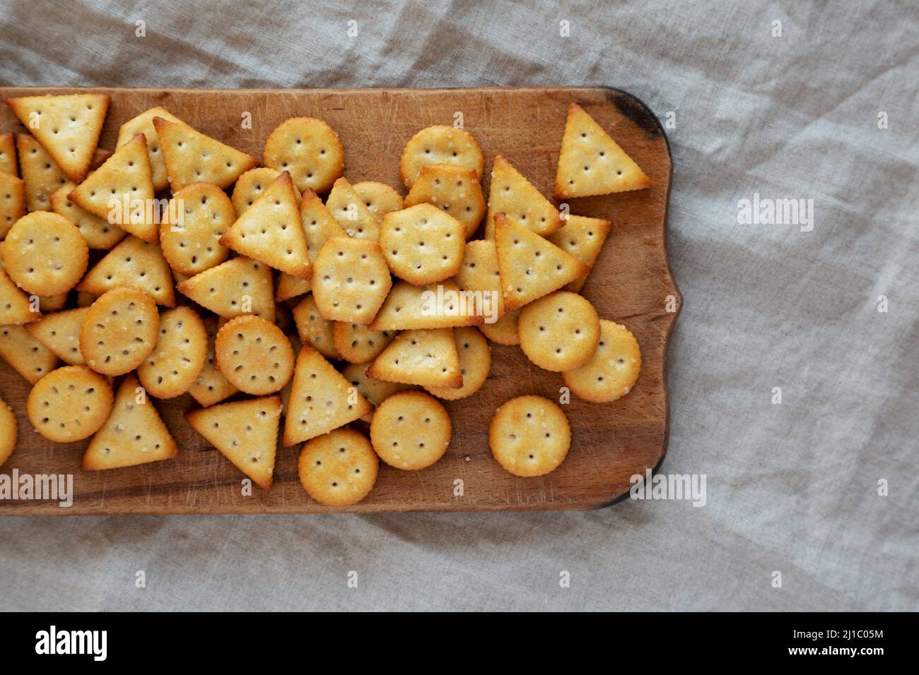 Happy birthday. Text from the salty crackers as printed English letters  that lie on a wooden chopping board. Message, lined with edible letters  Stock Photo - Alamy