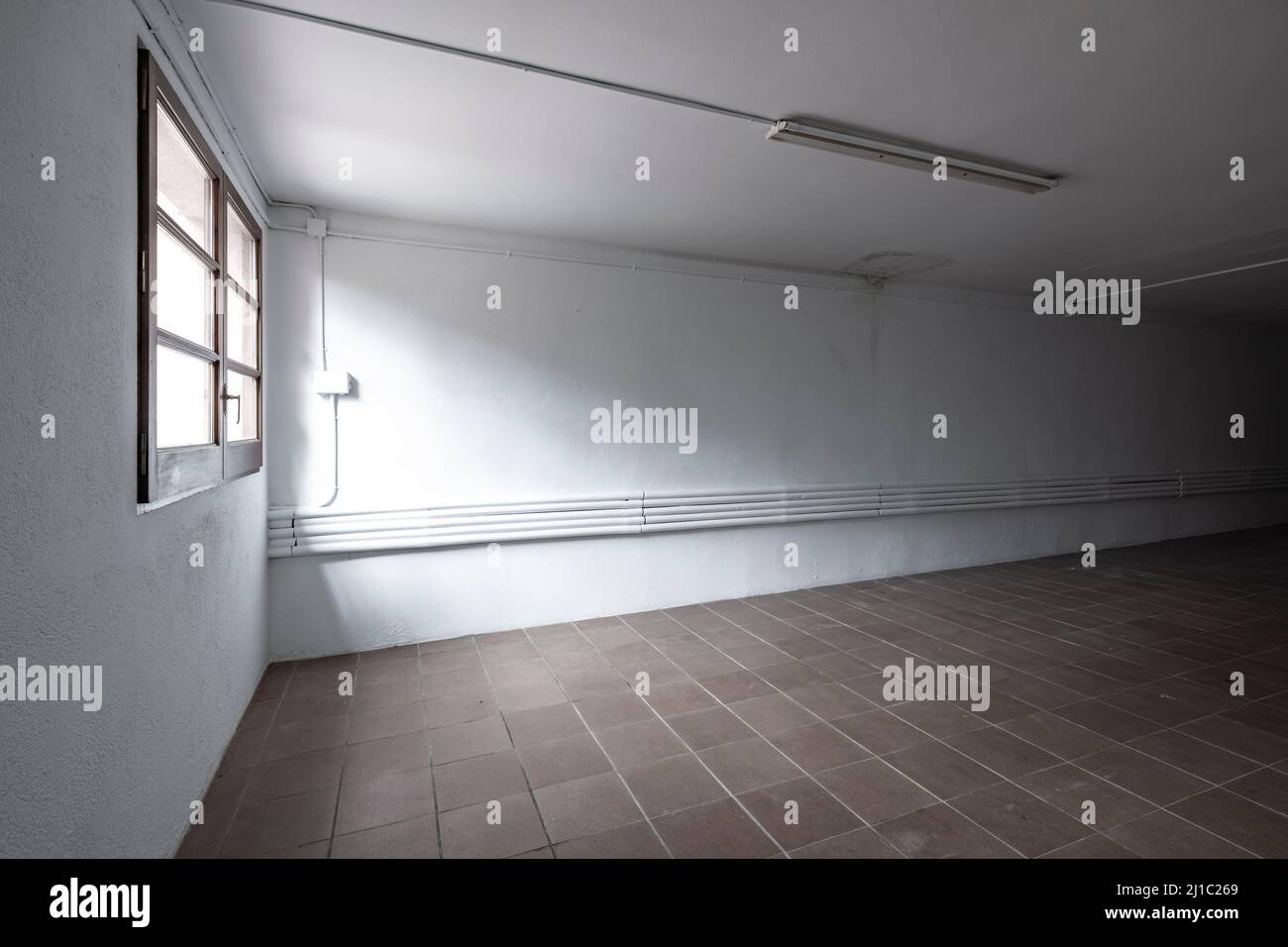 empty room of a warehouse in white color with a window Stock Photo