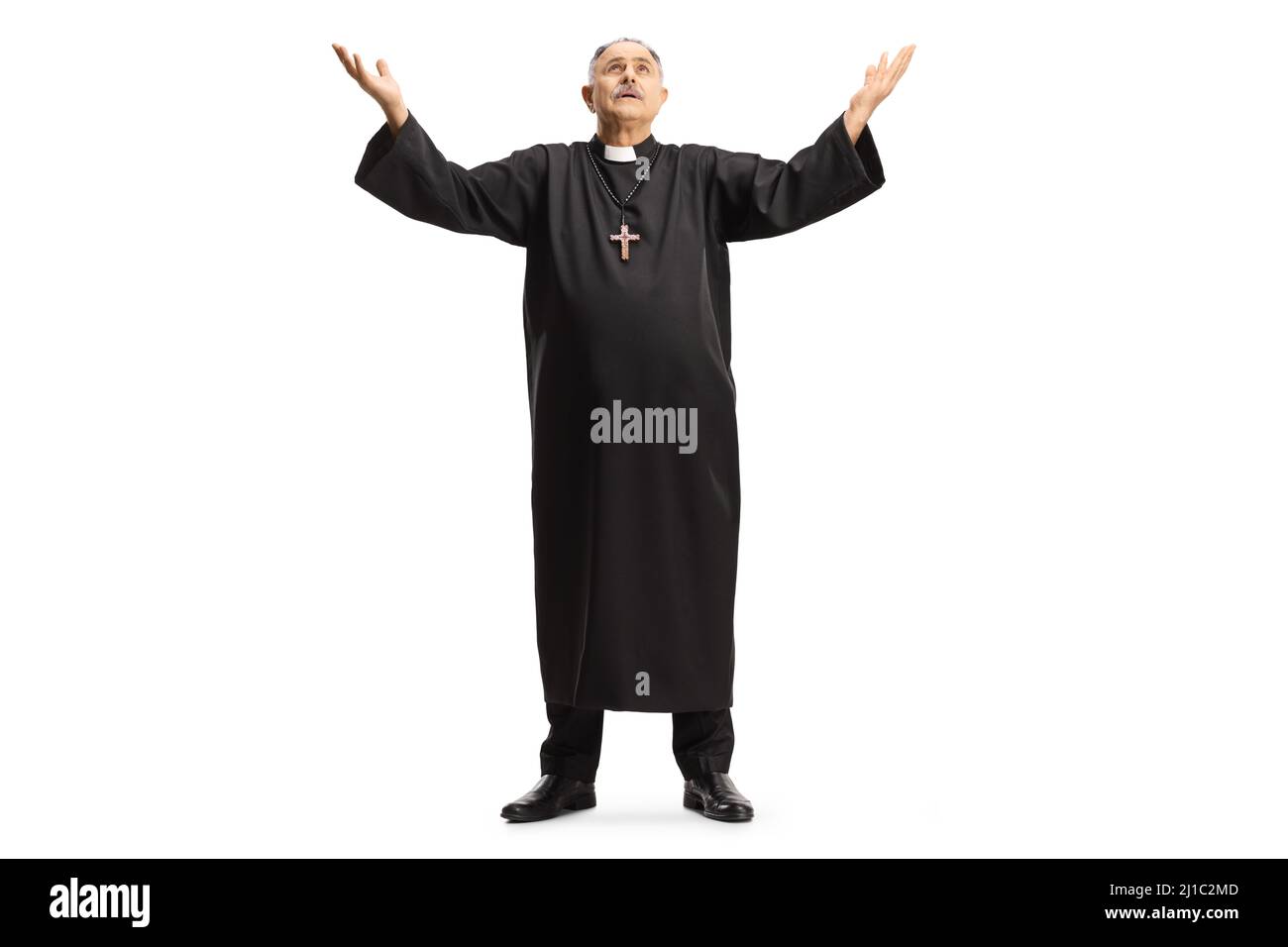 Full length portrait of a priest raising arms towards sky isolated on white background Stock Photo
