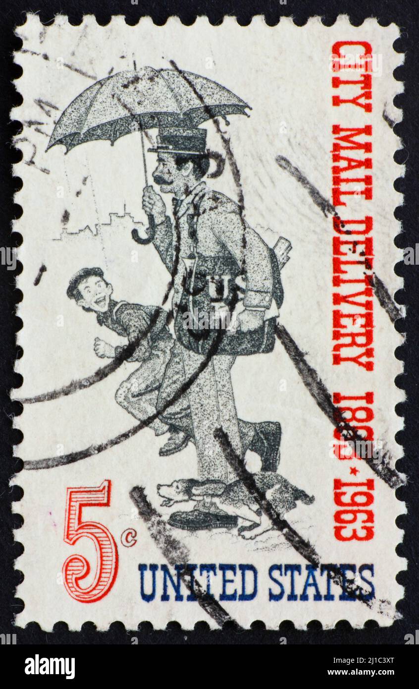 UNITED STATES OF AMERICA - CIRCA 1963: a stamp printed in the United States of America shows Letter Carrier, centenary of free city mail delivery, cir Stock Photo