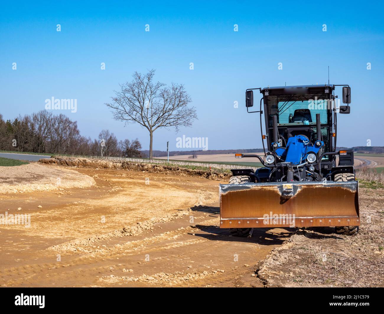 Construction machine for a new road construction Stock Photo