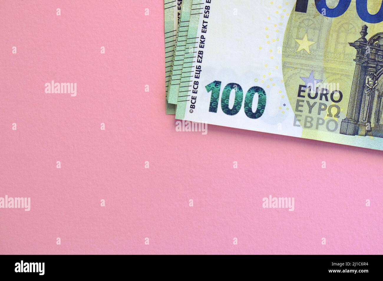 Pack of euro banknotes on pink background. European currency, business, finance Stock Photo