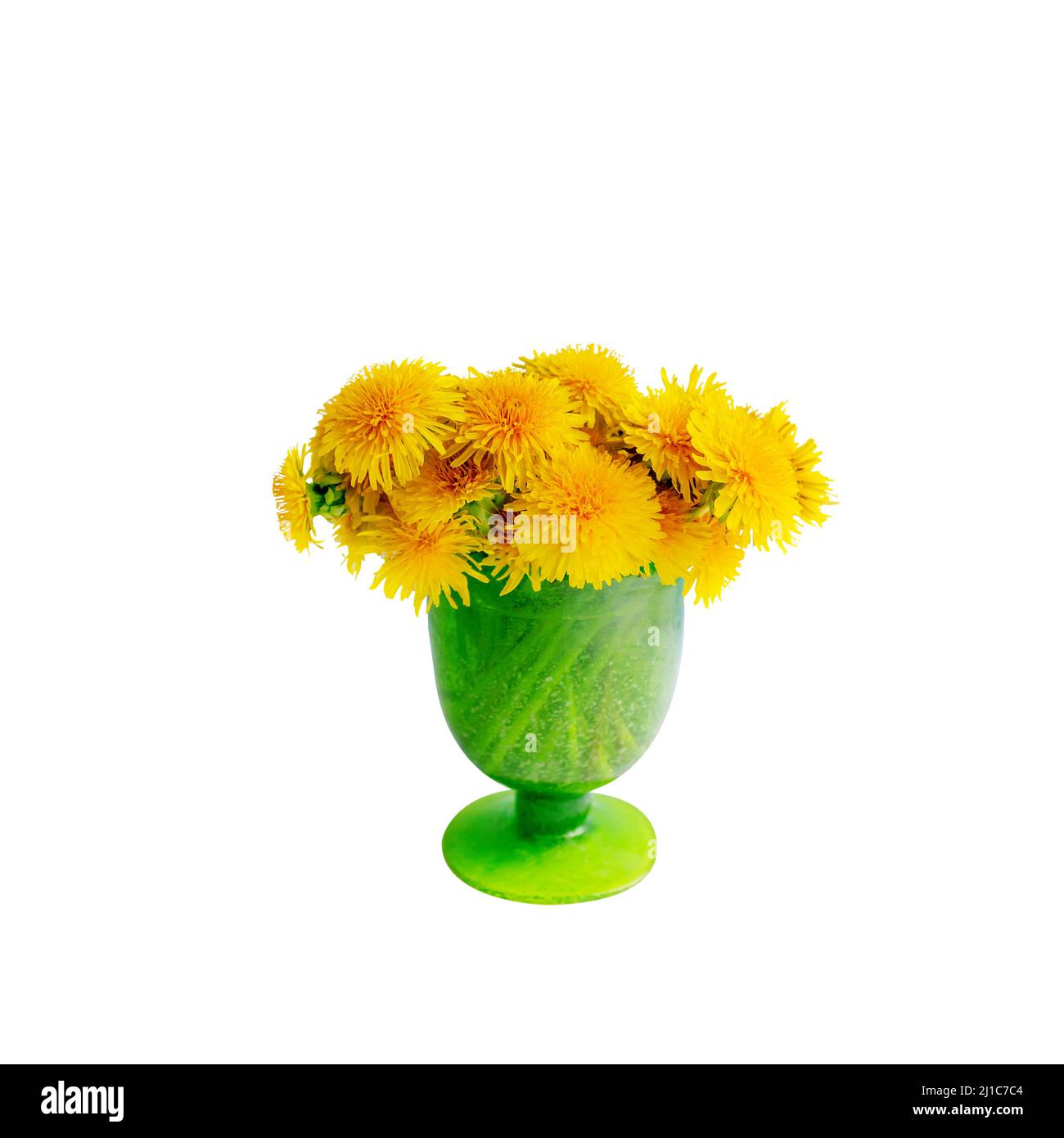 bouquet of yellow dandelions stands in a vase of green glass in a close ...